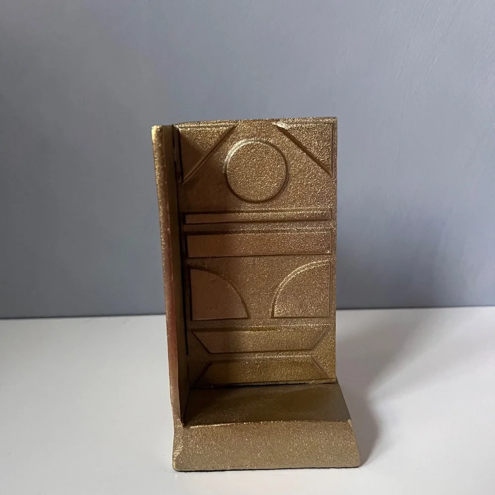 West Elm sculptural bookend in textured antique gold finish.